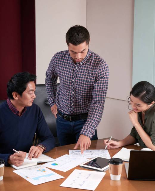 Businessman showing report he made to coworkers